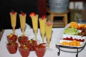 Bellini and Bloody Mary glasses and a bowl of fruits