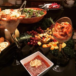 Bowls of shrimp dishes, salads, and fruits
