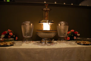 A lamp that looks like a fountain and two glass jugs of water